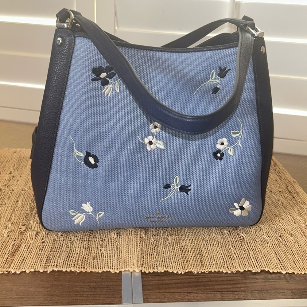 Kate Spade handbag. Dark blue with light blue fabric flowers stitching